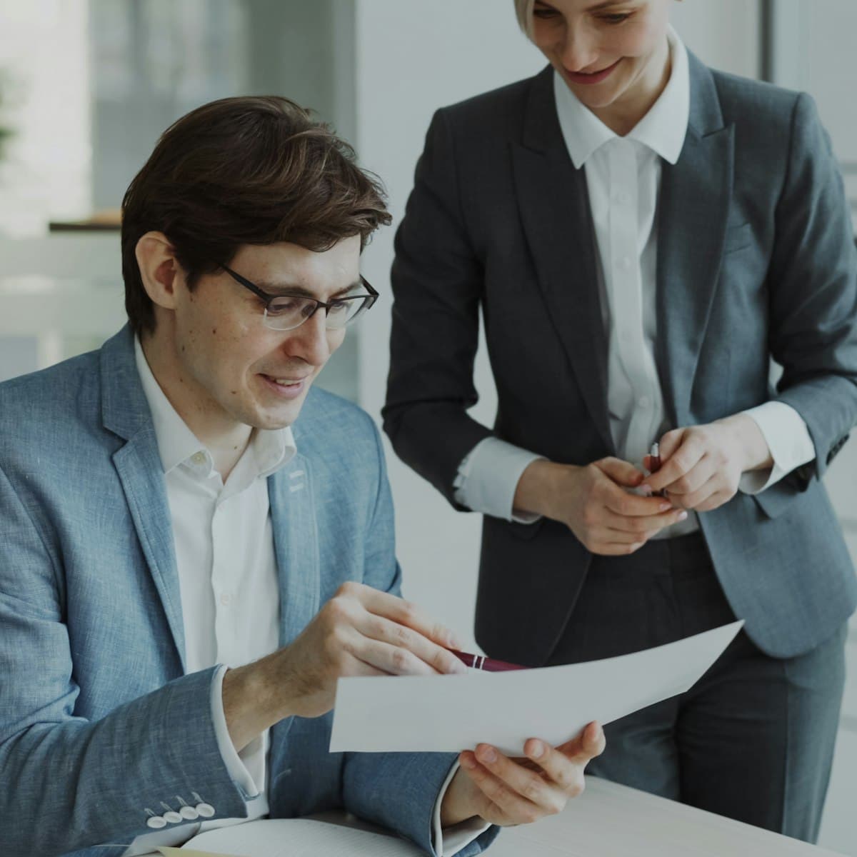 A loan officer and a realtor reviewing a document together